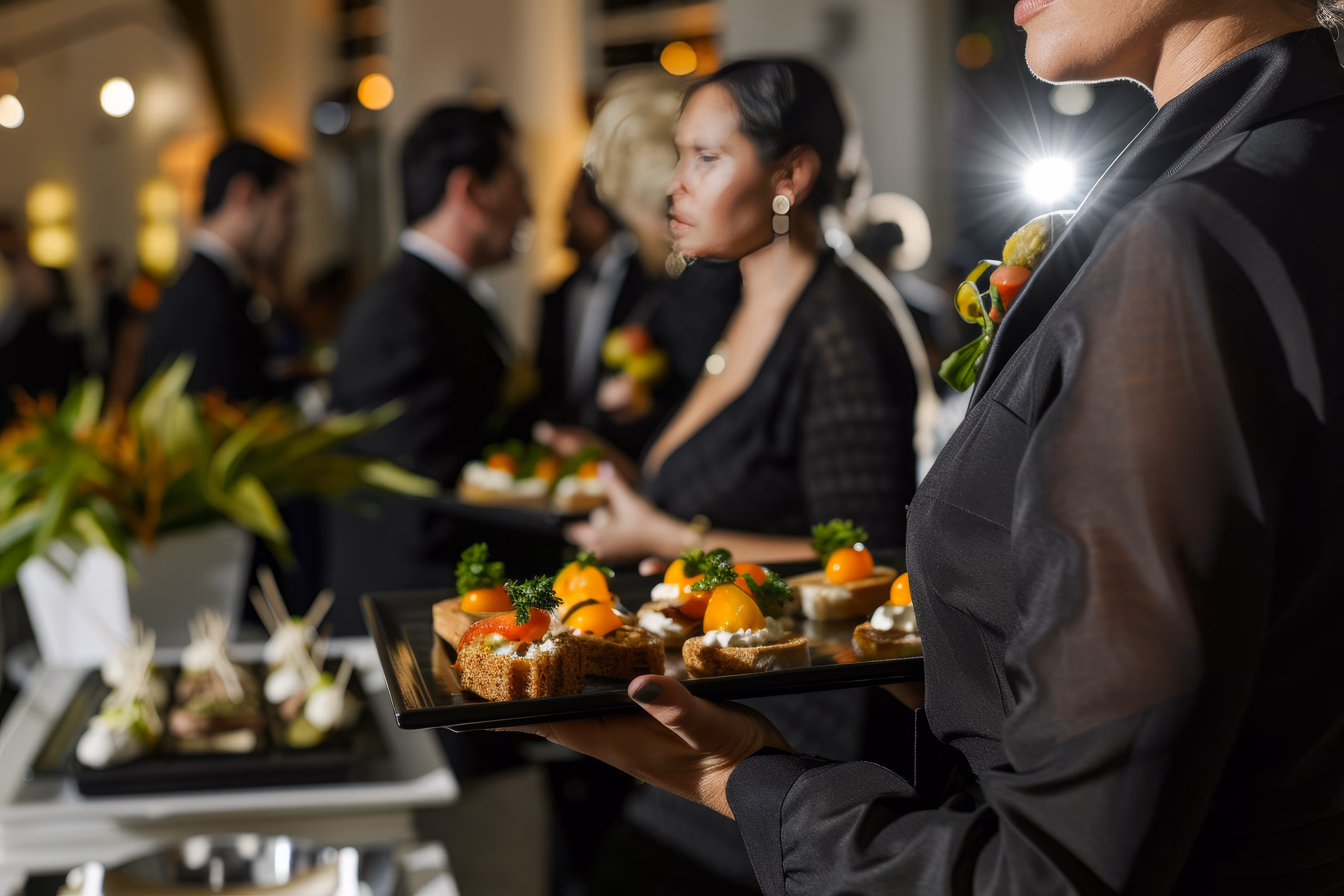 Server presenting gourmet hors d’oeuvres at an elegant event by Exquisite Delites, Atlanta.
