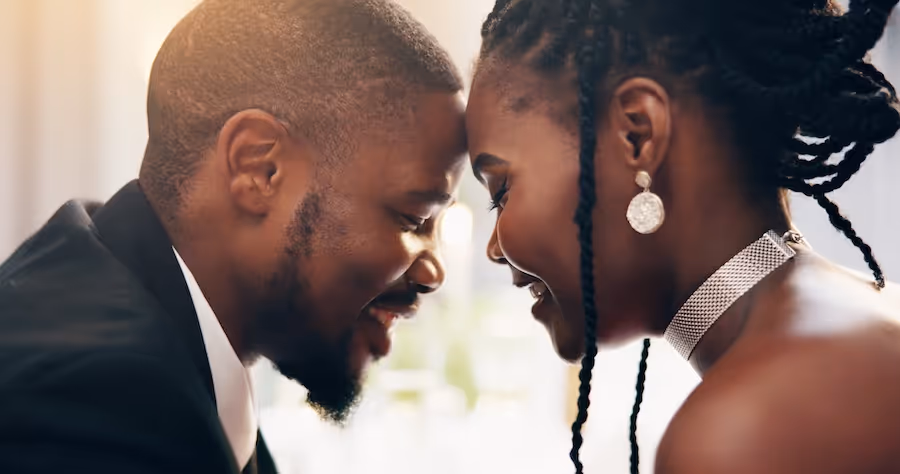 Bride and groom share an intimate moment at a reception catered by Exquisite Delites.