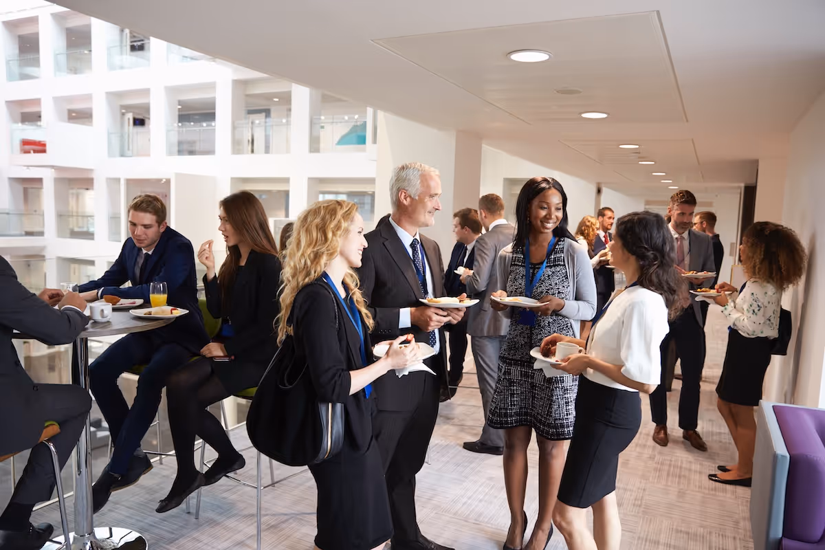 Business professionals networking at a catered corporate event by Exquisite Delites in Atlanta.