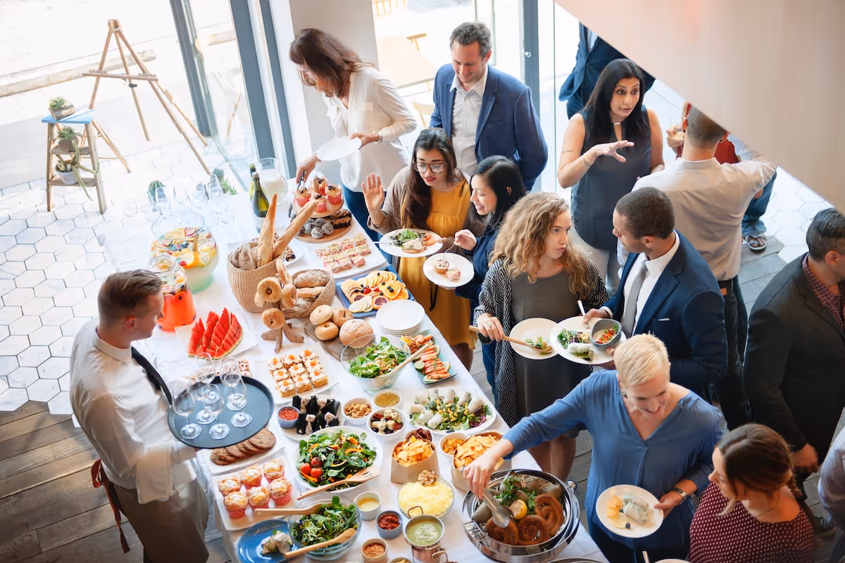Corporate buffet lunch with salads, breads, and gourmet dishes by Exquisite Delites.