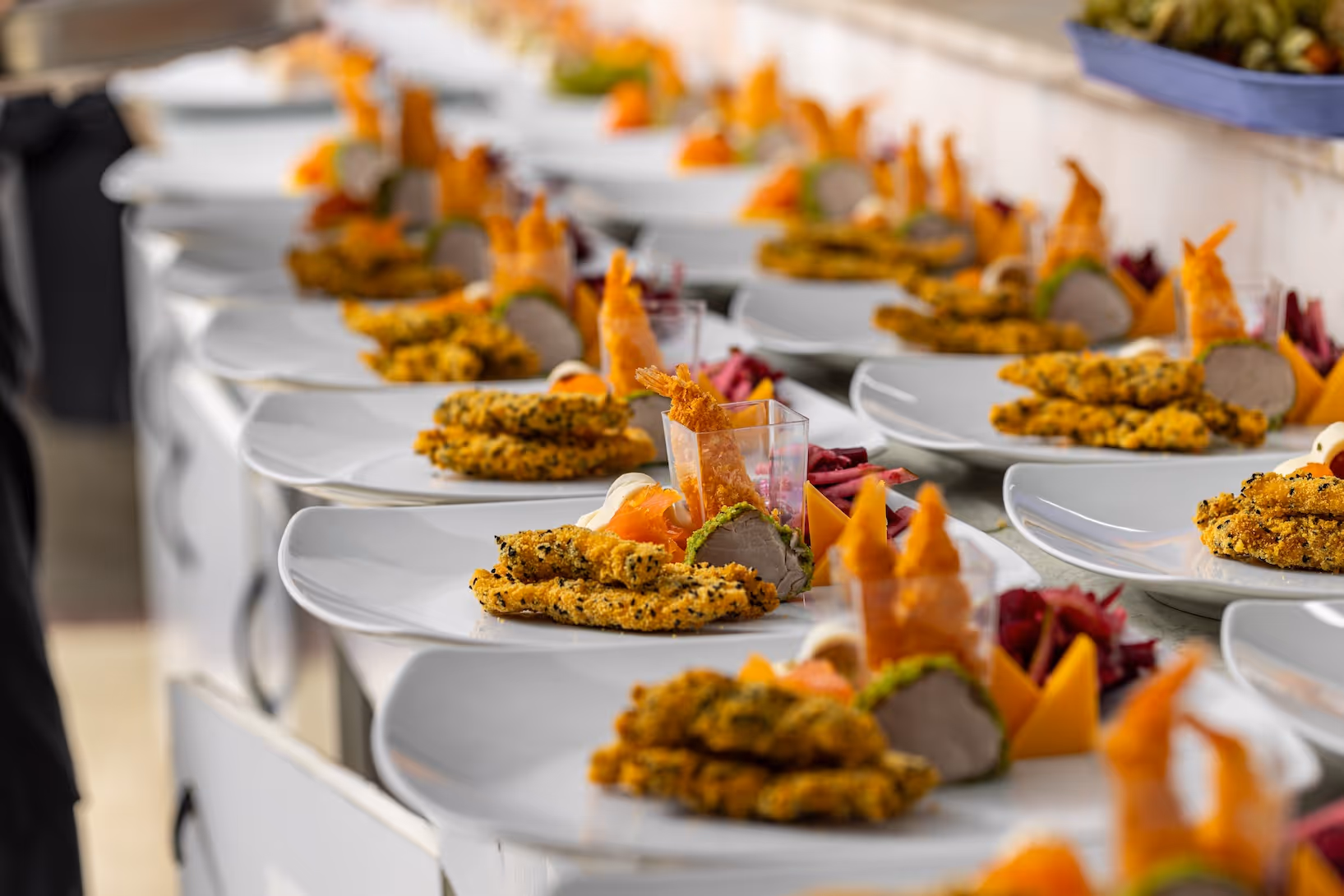 Rows of plated meals for cast and crew catering by Exquisite Delites on an Atlanta film set.