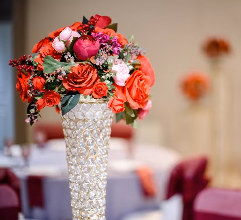 Red and pink rose centerpiece in a crystal vase by Exquisite Delites, Atlanta weddings.