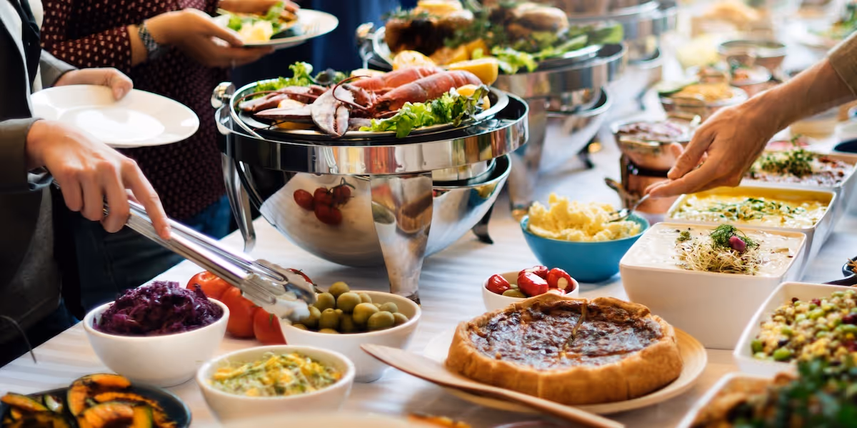 Corporate team enjoying a buffet-style breakfast spread with fresh pastries, fruits, and savory dishes catered by Exquisite Delites to boost workplace productivity.