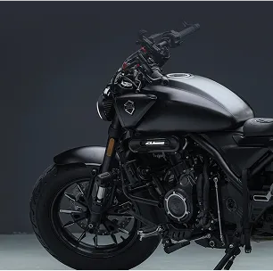 A black motorcycle parked in a dark room.