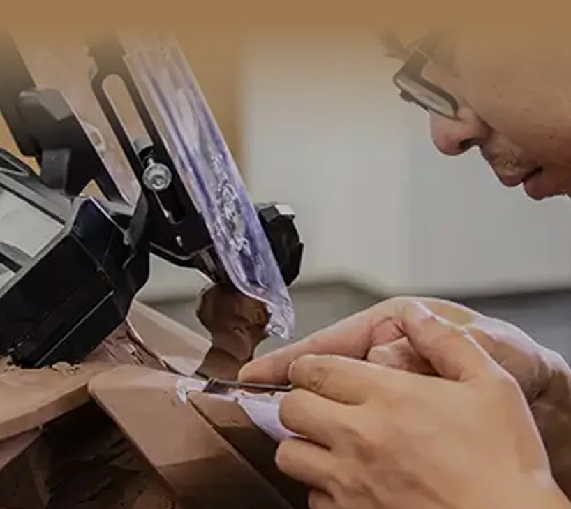 A man is working on a piece of paper.