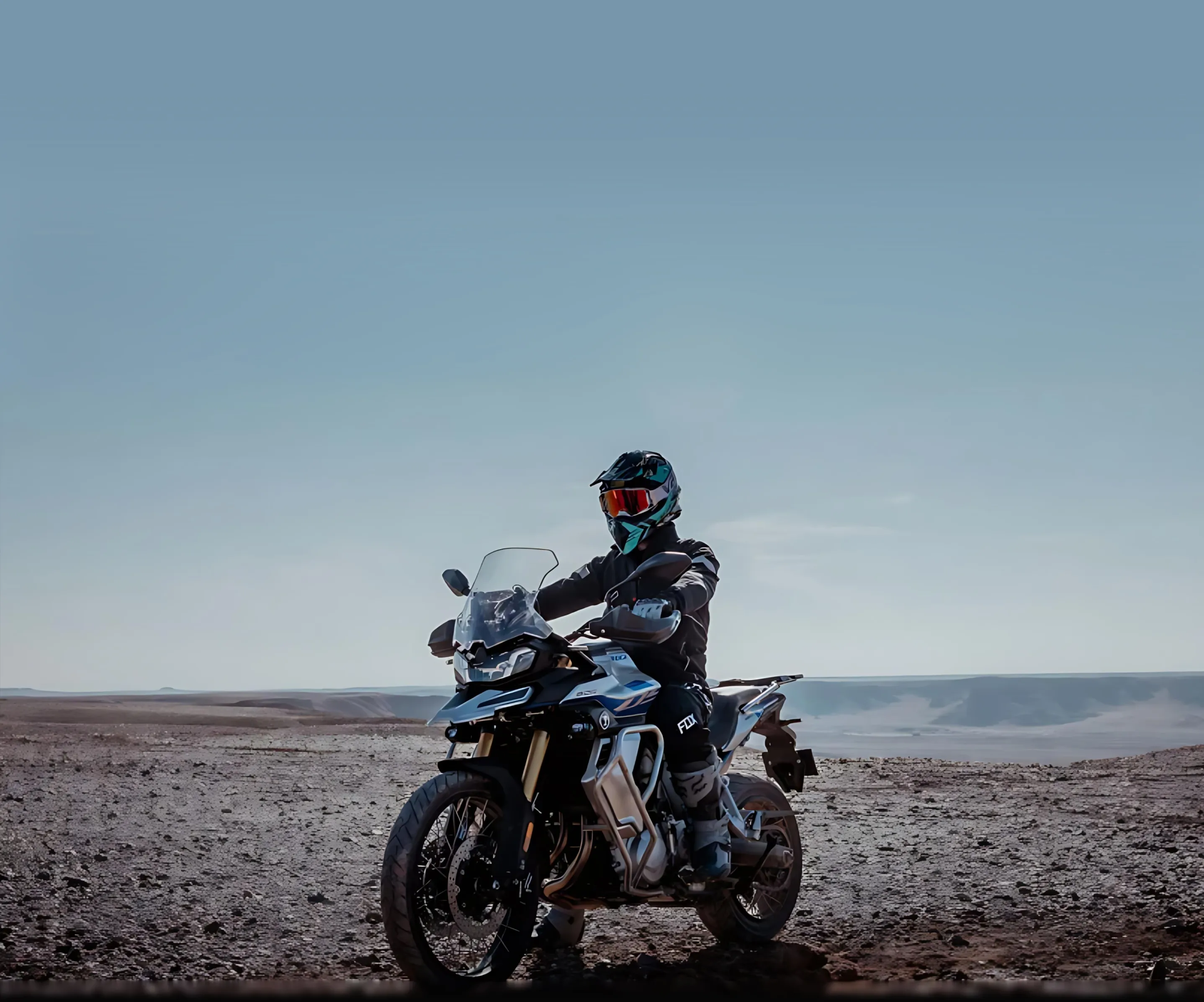 A person riding a motorcycle on a dirt road.