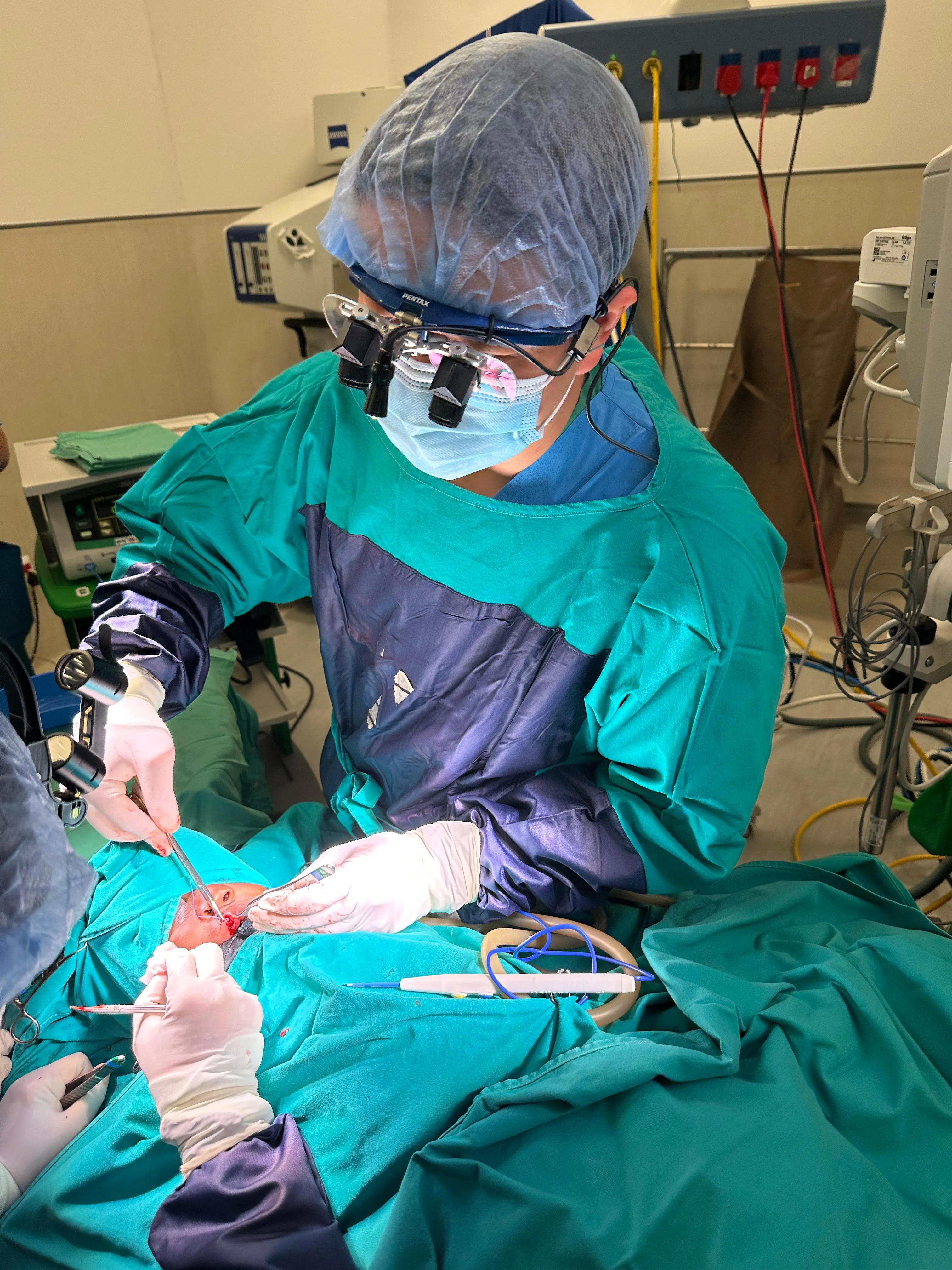 Dr. Noah Teo, Specialist Oral Surgeon at Orchard Scotts Dental performing an oral surgery