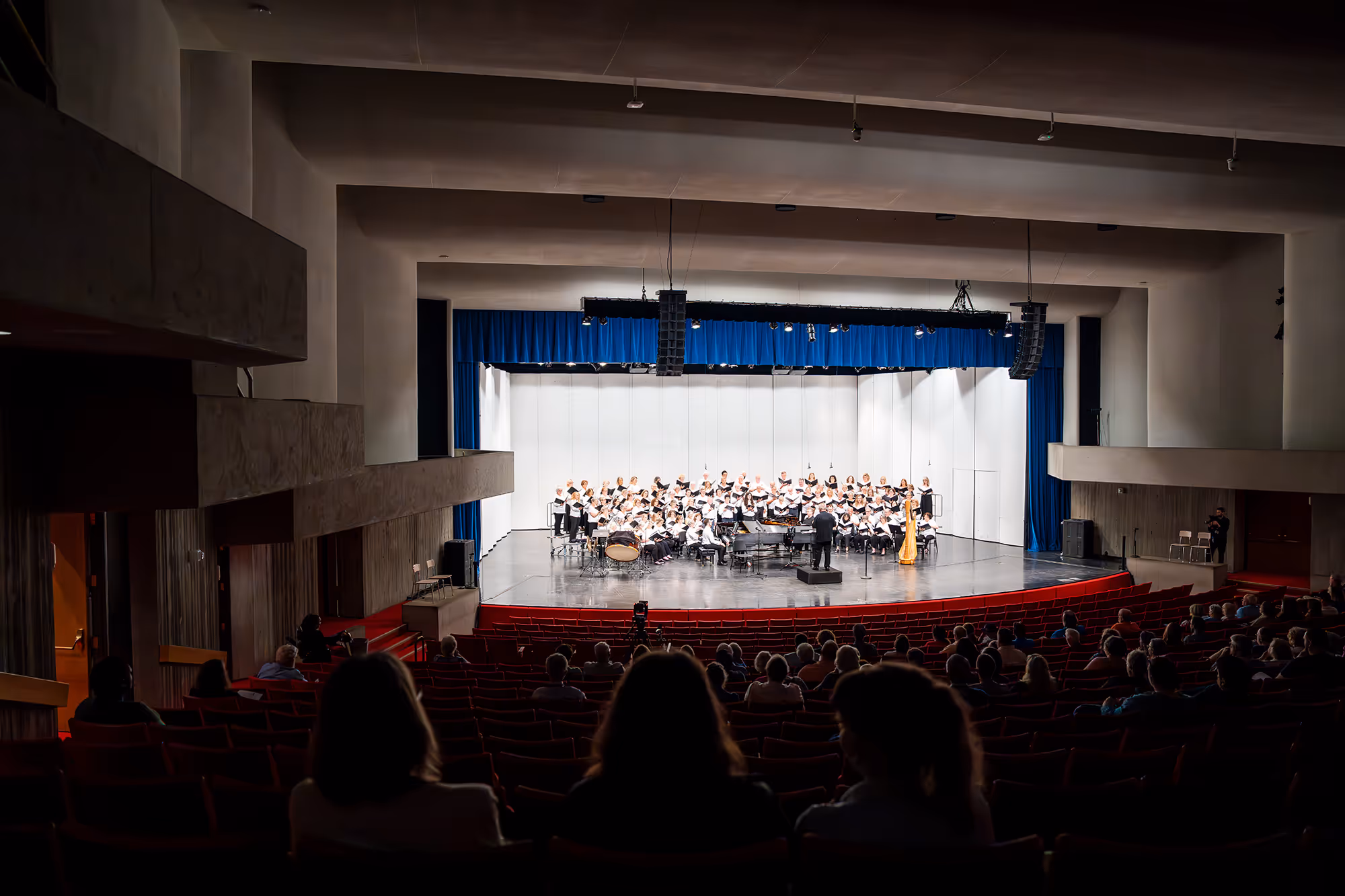 View of an orchestra on stage in a music hall.