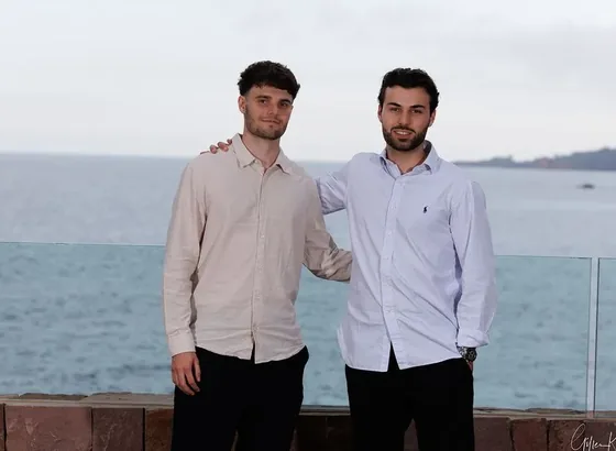 Two Noqode team members by the sea