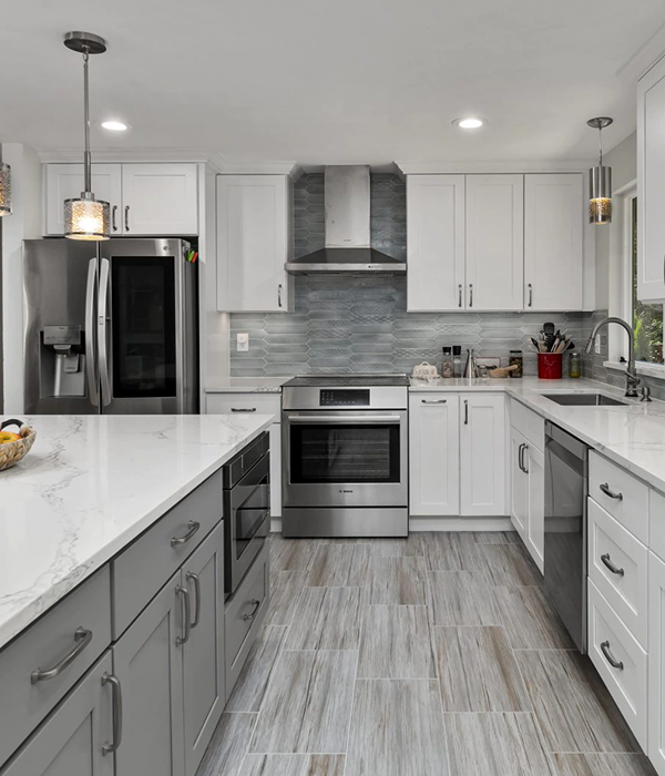  modern kitchen remodel featuring sleek white upper cabinets, gray lower cabinets, stainless steel appliances 