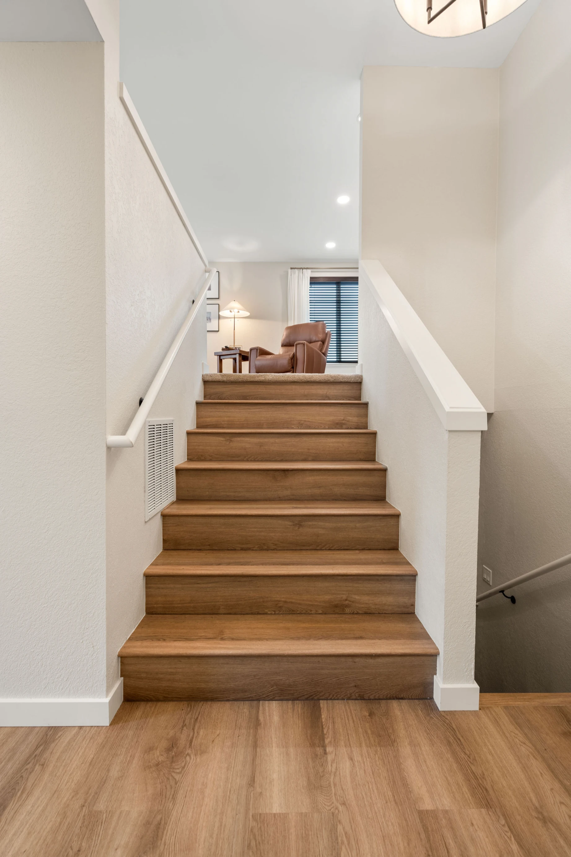 Renovated interior stairs in Bellevue home after Phase 1 remodel with modern detailing