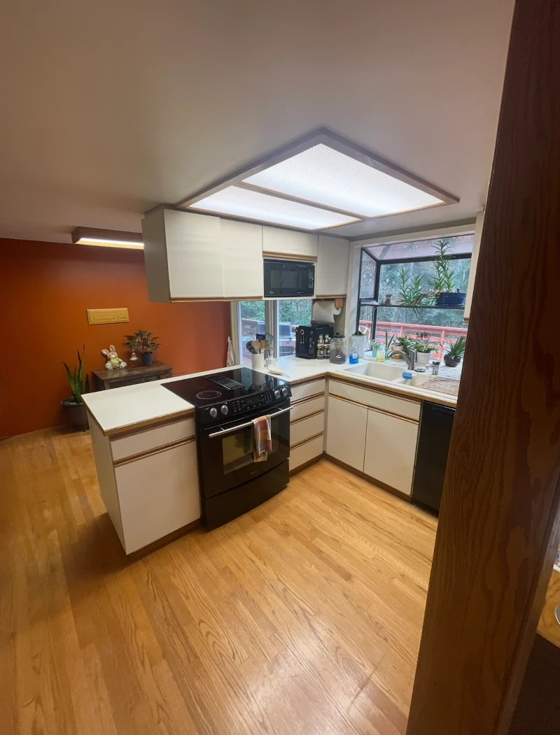 Outdated Bellevue kitchen before renovation with boxed ceiling lighting and limited workspace