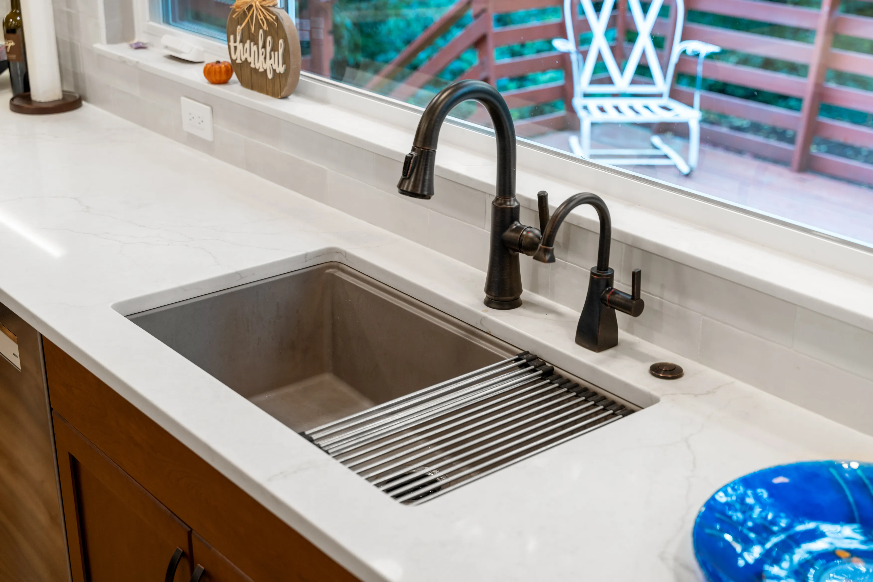 Kitchen sink centered under large window in Bellevue home after remodel