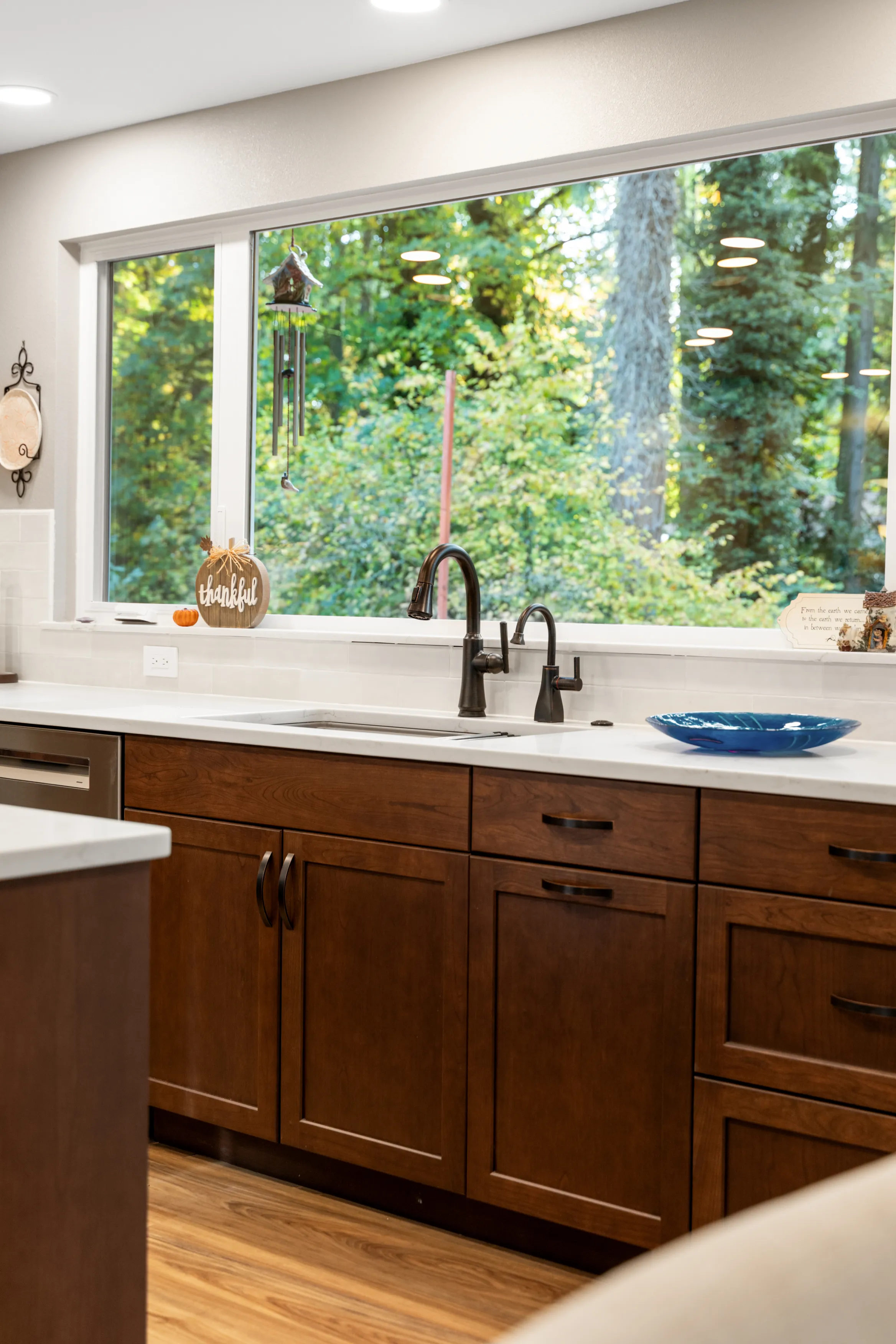 Bright open kitchen in Bellevue home after remodel with island and modern lighting