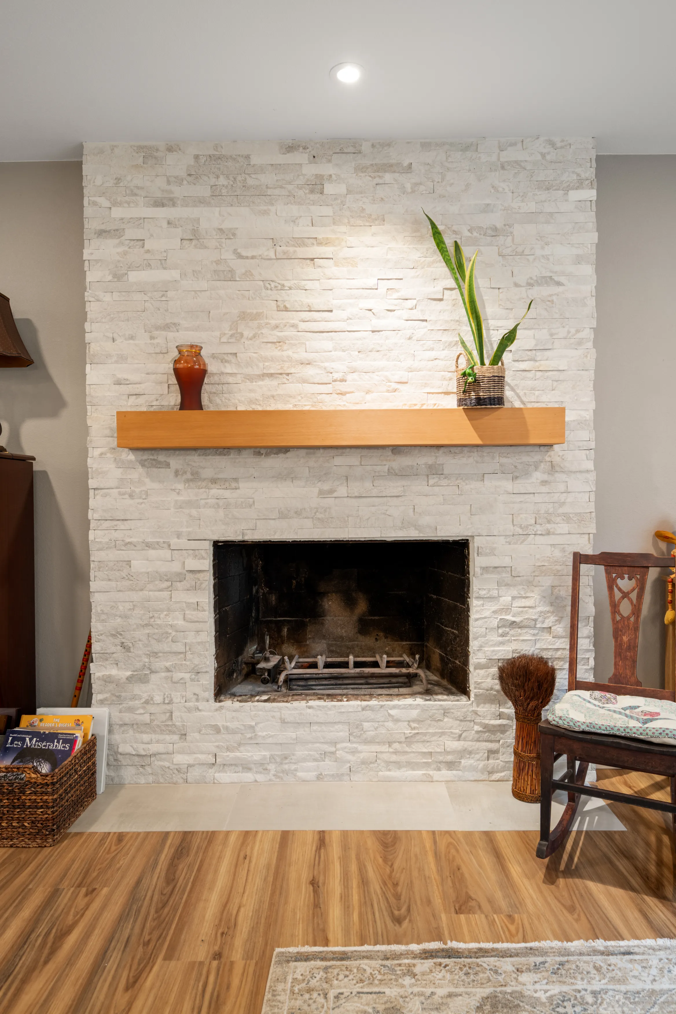 Updated fireplace in Bellevue home after remodel with white stone surround and floating mantel