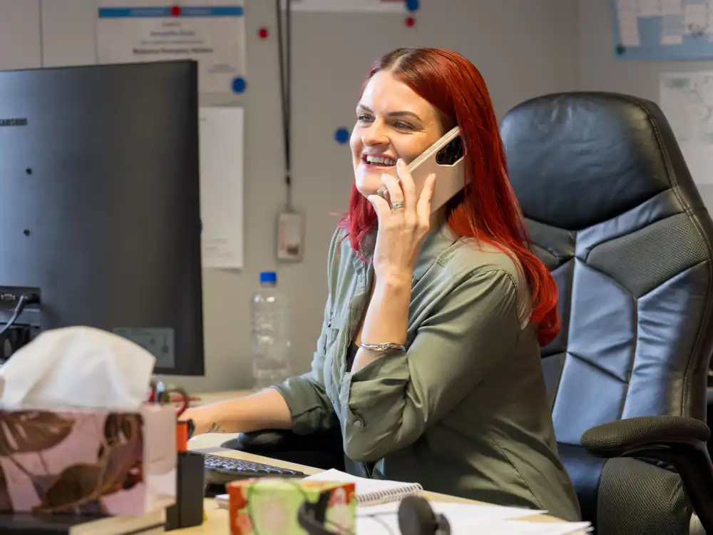 WasteCo team member supporting a customer via telephone