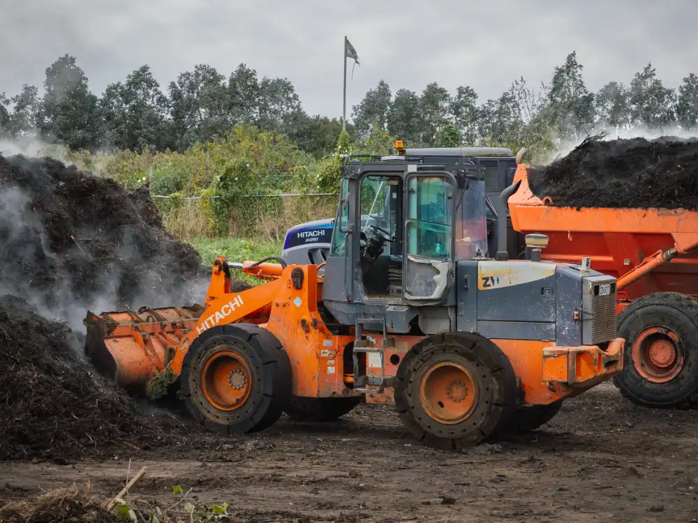 A front-end loader working at a landfill managed by WasteCo
