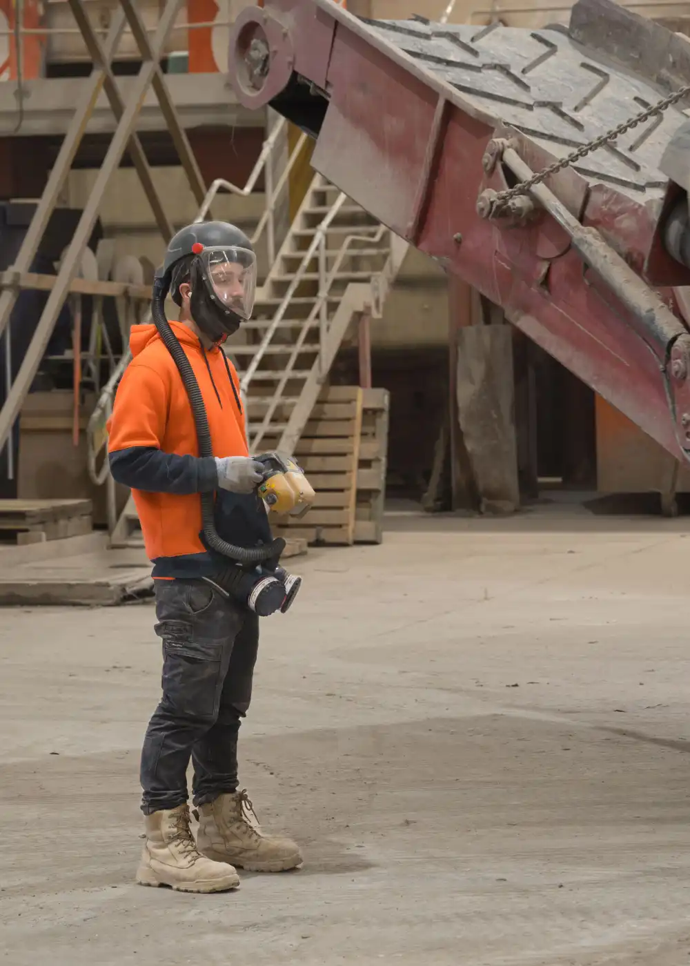 A WasteCo team member in safety gear at the sorting facility