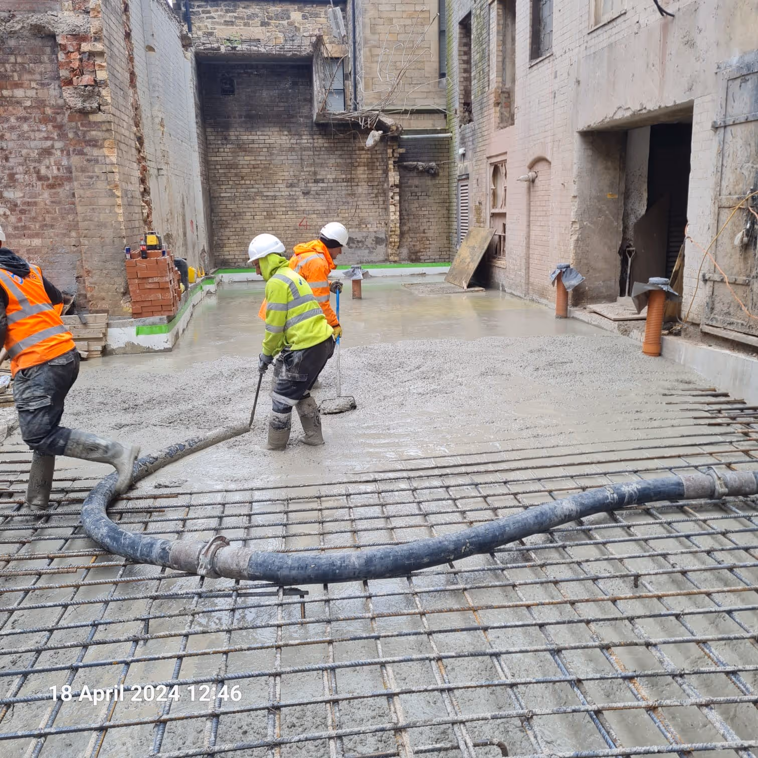 Operatives pouring concrete slab