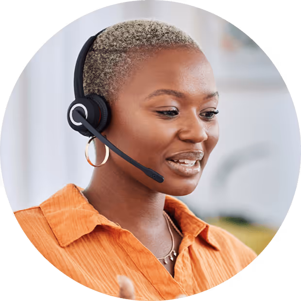 Woman with headset smiling while working in customer support