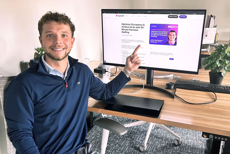 Team member pointing at ShyftOff website on desktop screen