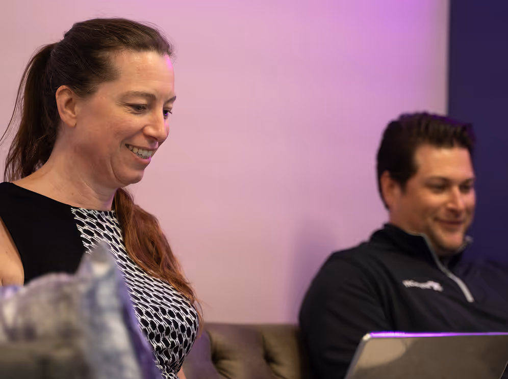 ShyftOff colleagues smiling and collaborating during a meeting
