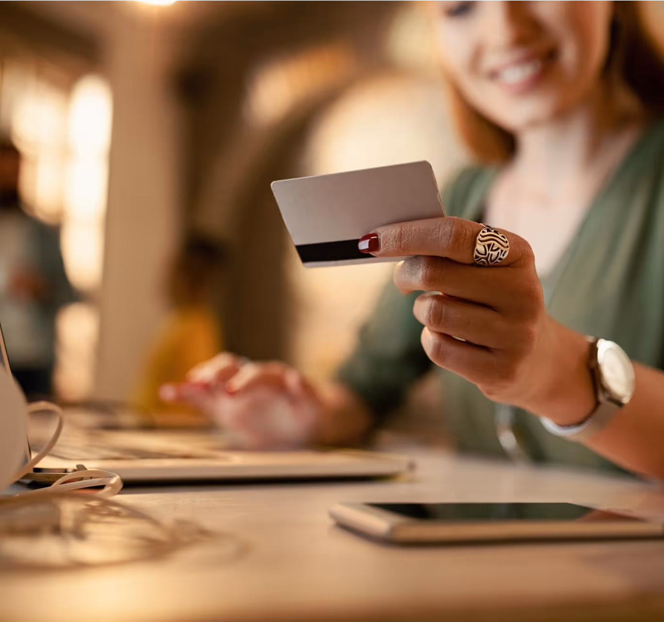 Woman holding credit card while making an online payment on laptop