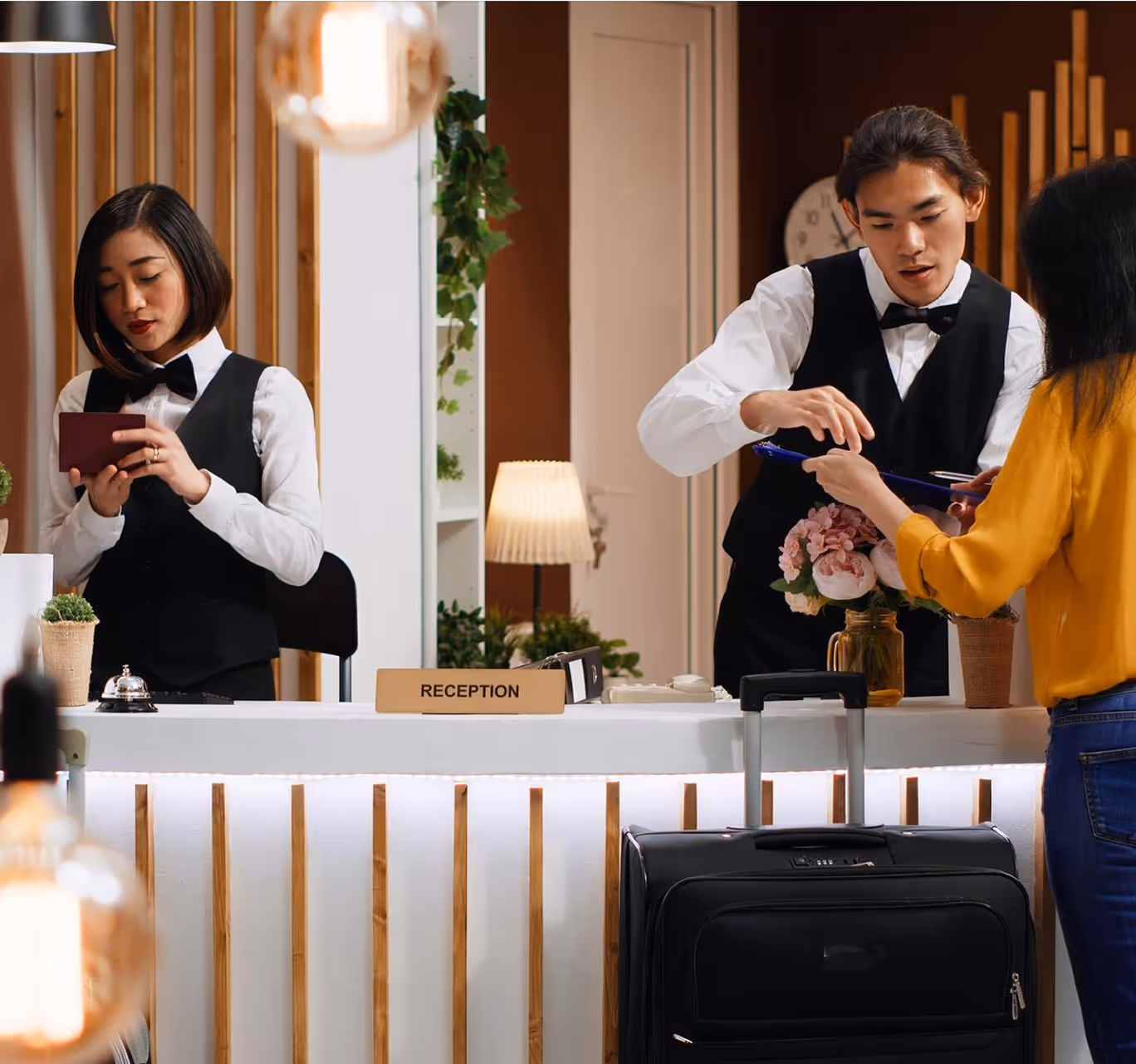 Hotel reception staff assisting guest with check-in process