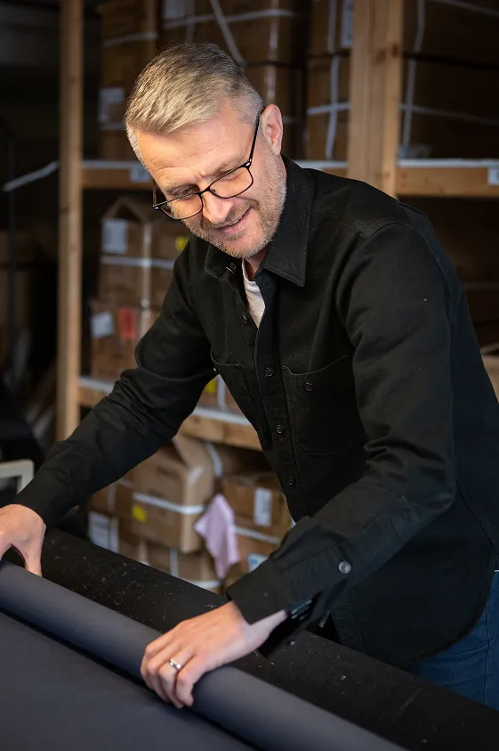 Nick from Stereo working with rolls of fabric.