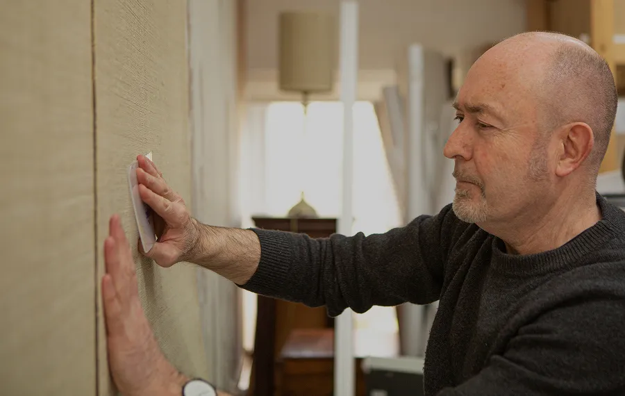 Martyn from Stereo Interiors hanging a luxury wallcovering.