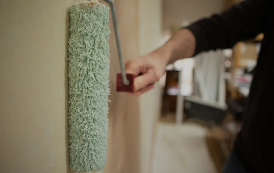Hanging rolls of textured luxury fabrics in a showroom setting.