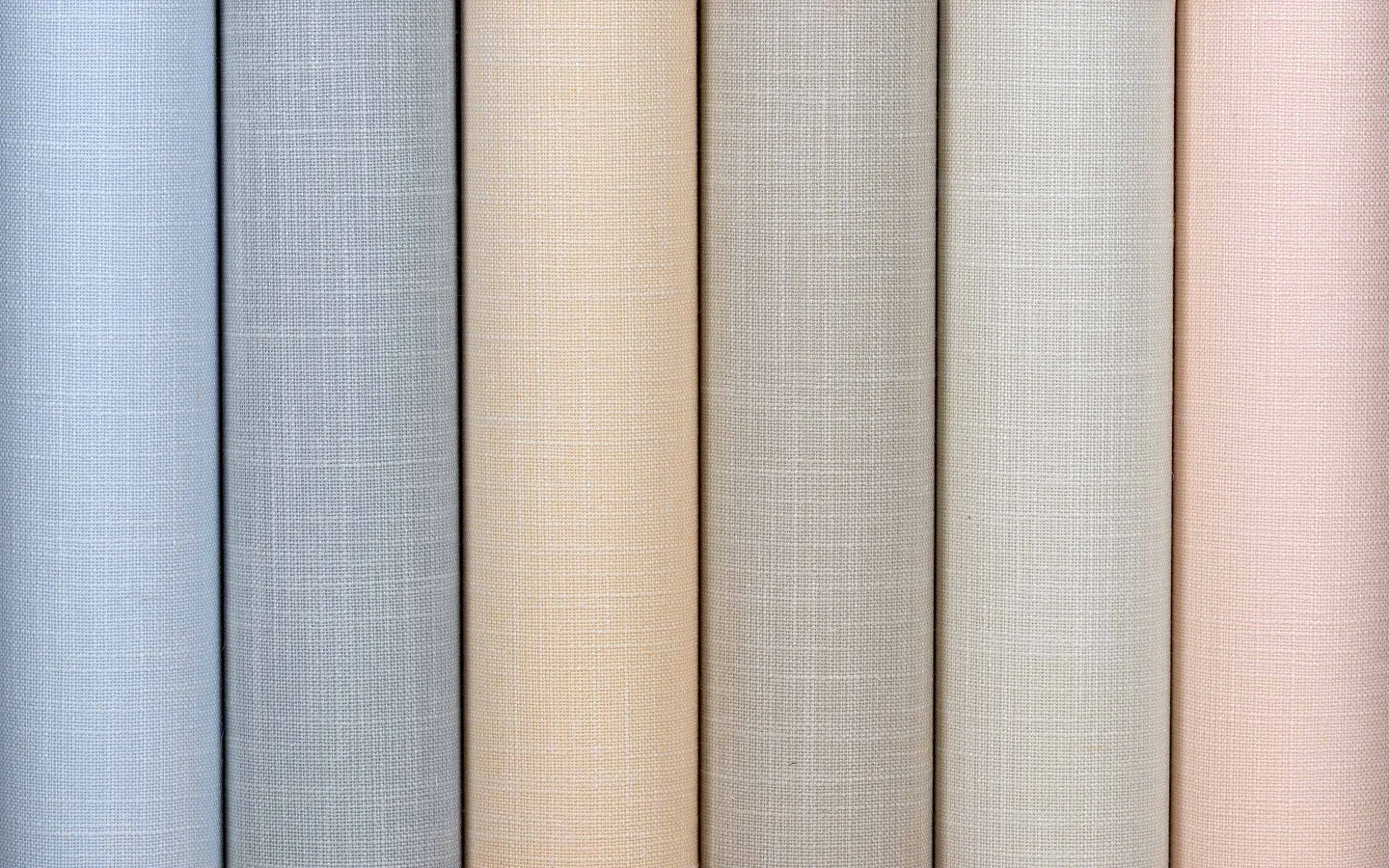 Soft pastel fabric wallcoverings in luxury woven textures.