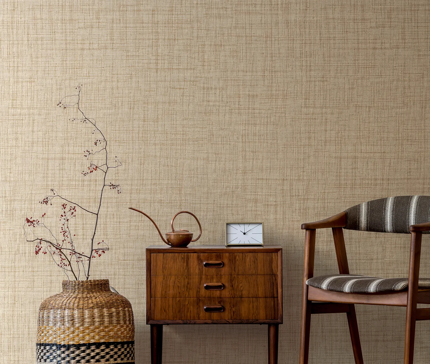 Luxury wallcoverings in a neutral palette styled in a modern setting with a large vase, small sideboard and wooden seat.