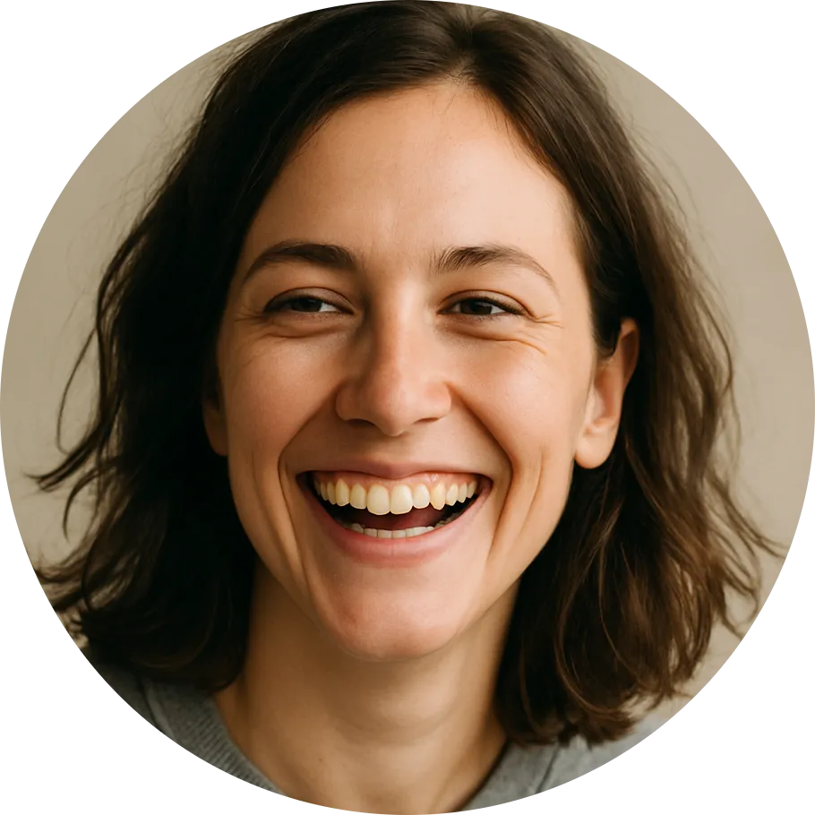 Smiling woman with short brown hair and wearing a gray top.