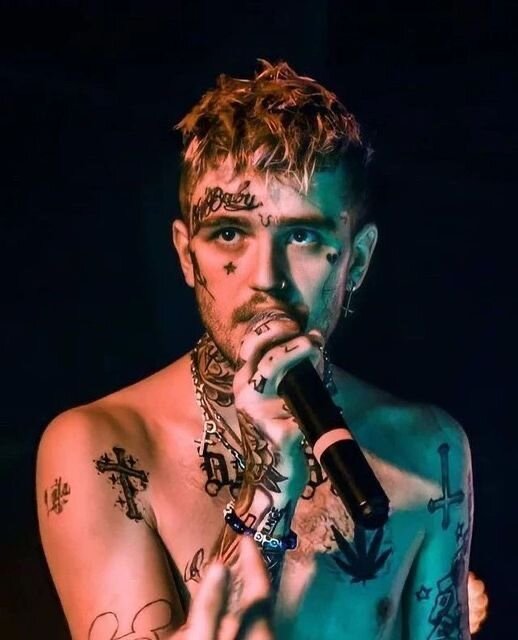 Rapper Lil Peep with tattoos and microphone