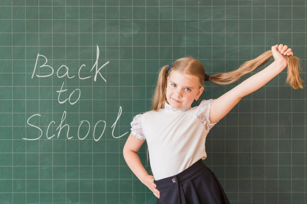 young girl posing in front of the class 