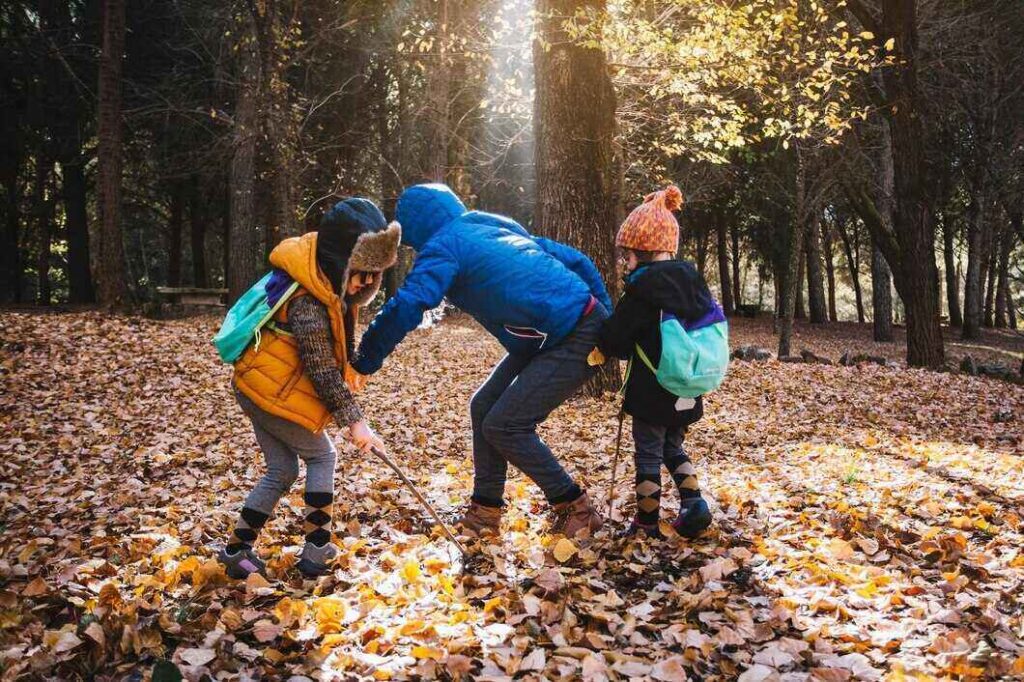 Kids enjoying seasonal adventure in the woods