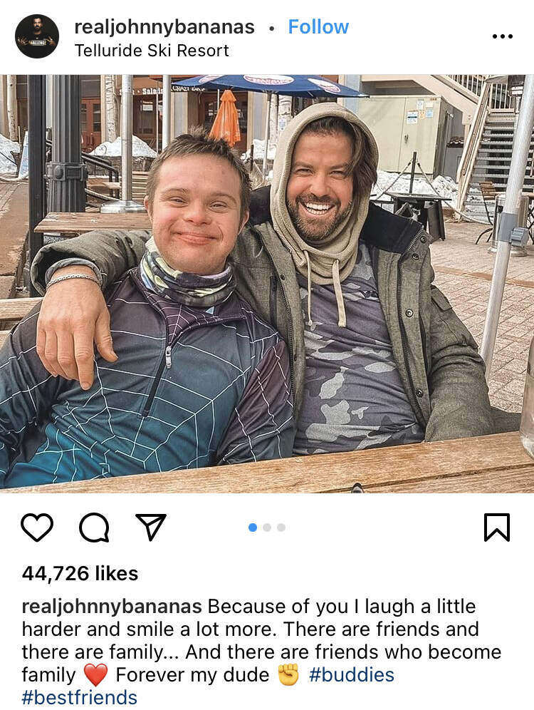 man with his arm around his friend