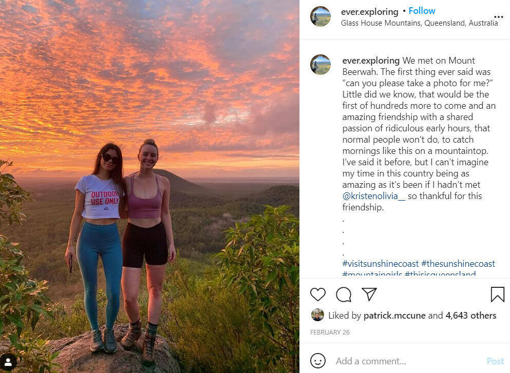 two women smiling with sunset behind them
