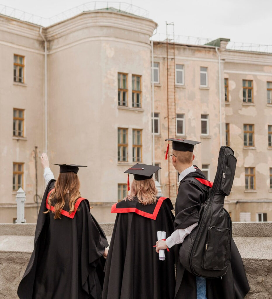 Three people celebrating their graduation with diploma