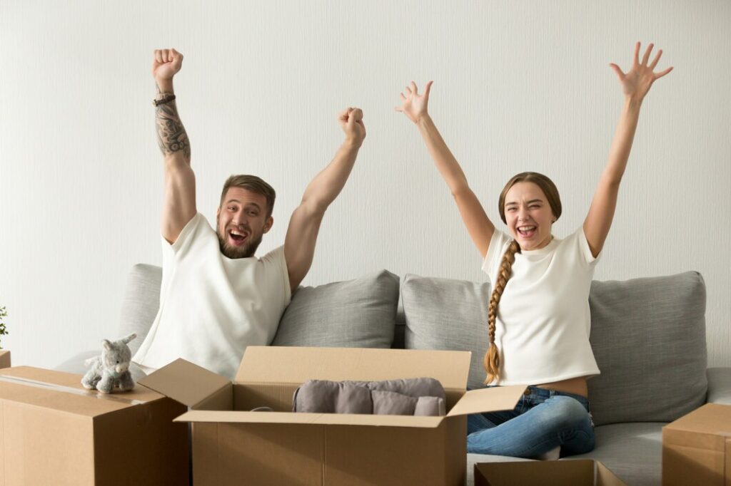 Young couple celebrating owning new home