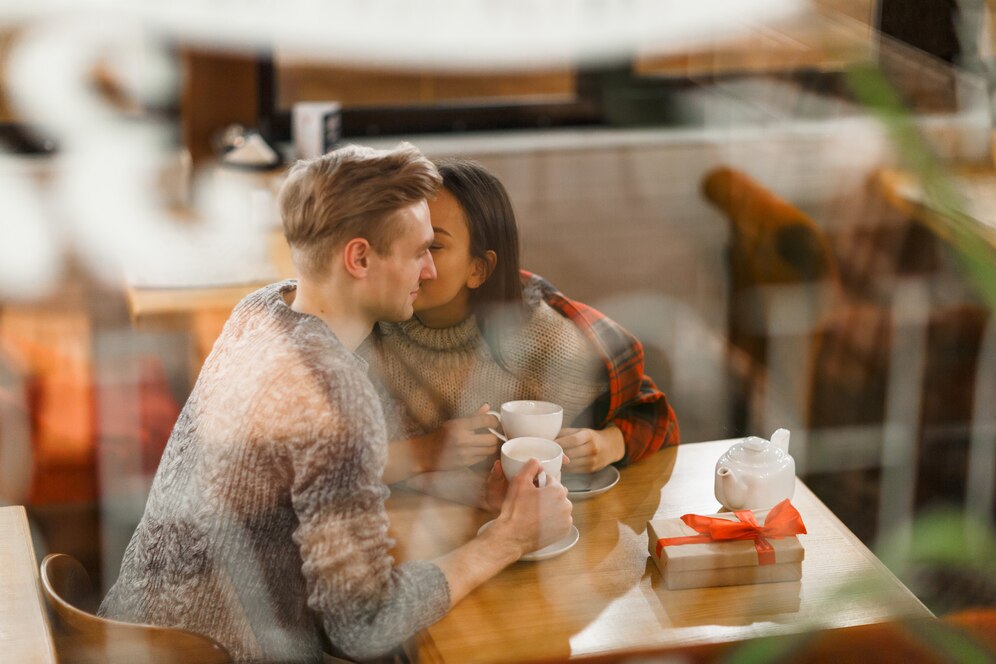 playful couple in a cafe