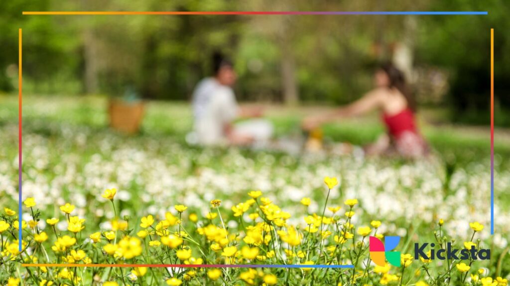 Spring picnic in flower field with friends