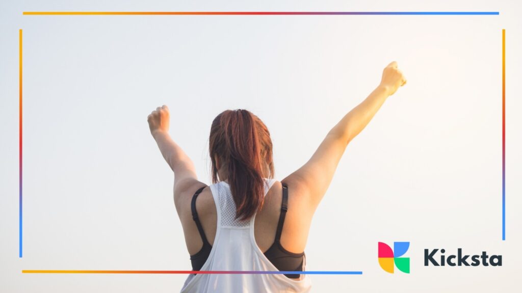 Fitness motivation with woman raising arms