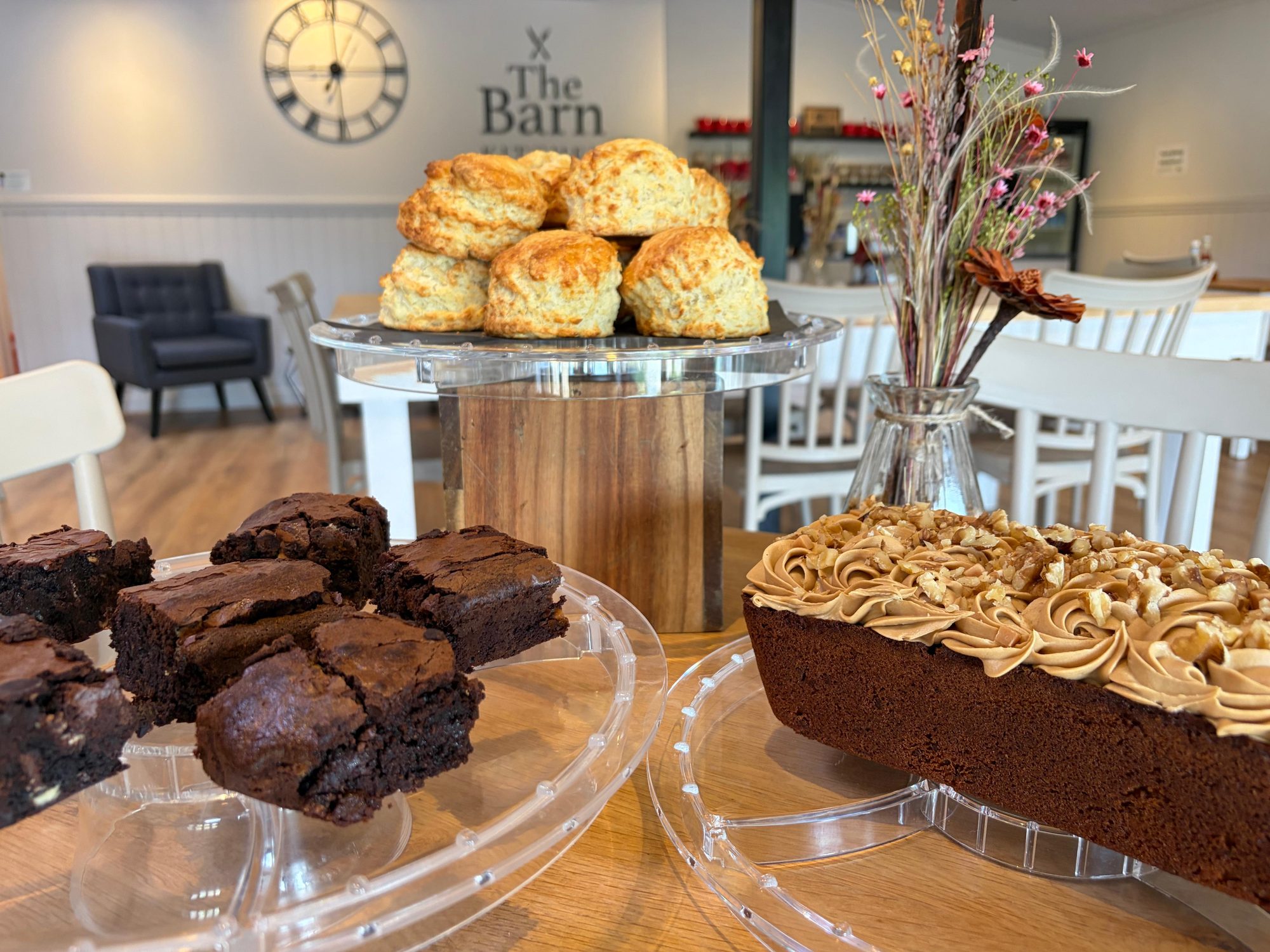 Freshly baked cheese scones, chocolate brownies and coffee and walnut cake on the counter at The Barn Kitchen