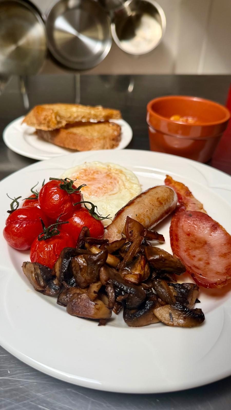 The Full Barn Breakfast with sausage, bacon, egg, mushrooms, vine tomatoes and sourdough toast