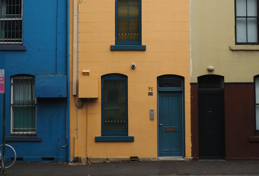 A row of colourful terrace houses on a city street