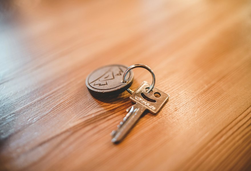 A set of house keys on a timber table