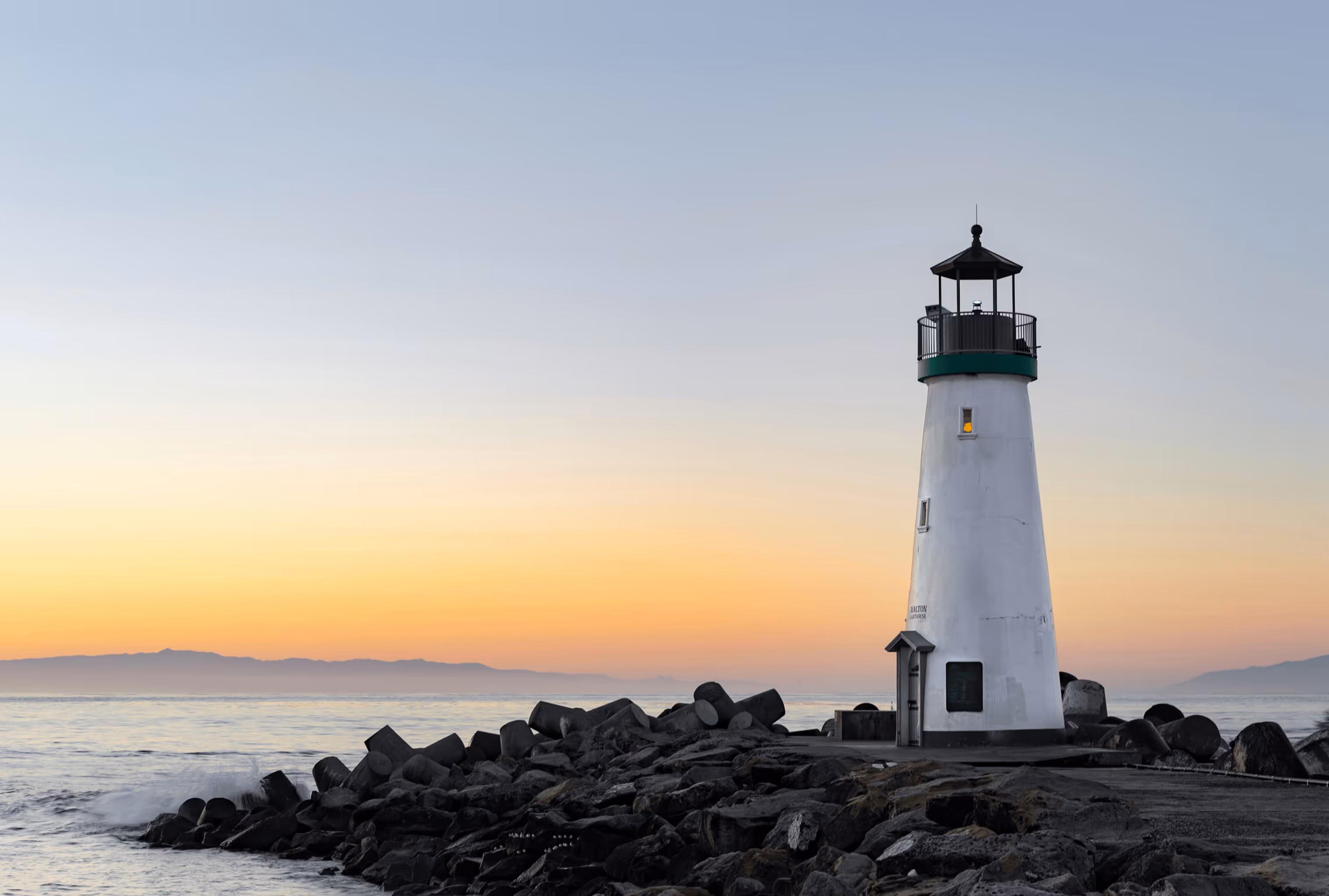 Lighthouse at sunrise guiding the way to clear financial planning