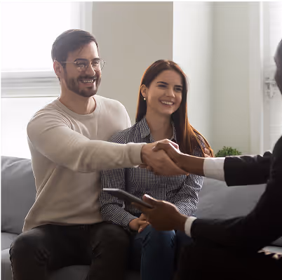 Clients smiling and shaking hands with advisor symbolizing personalized investment guidance